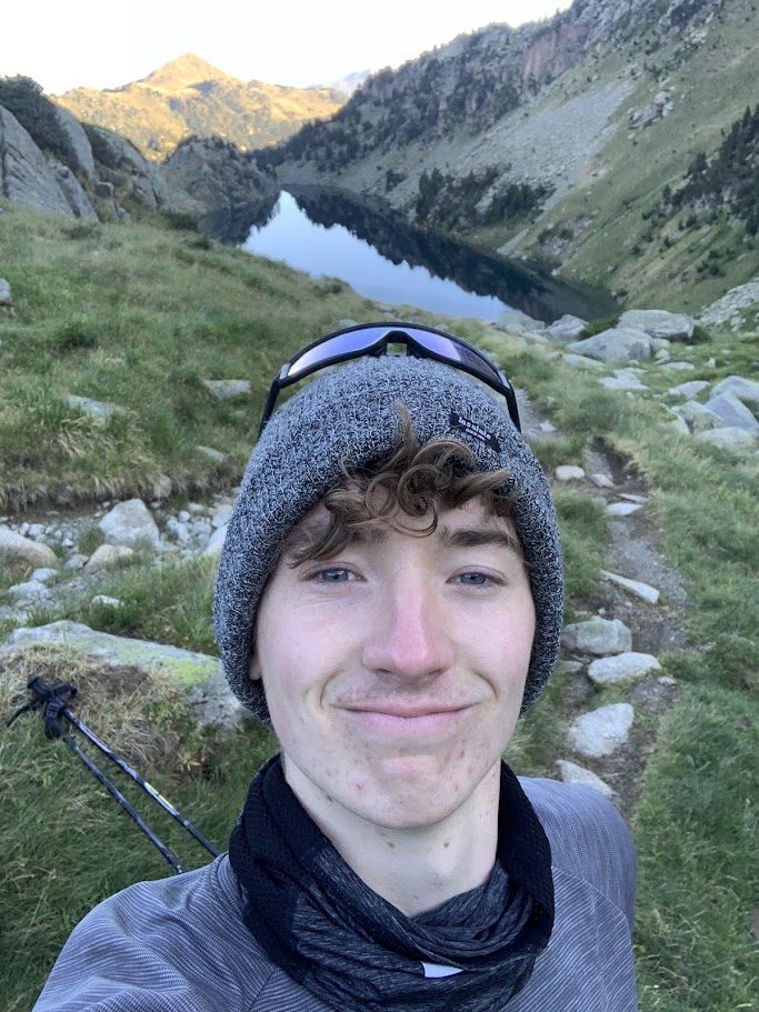 Evan hiking by a mountain lake